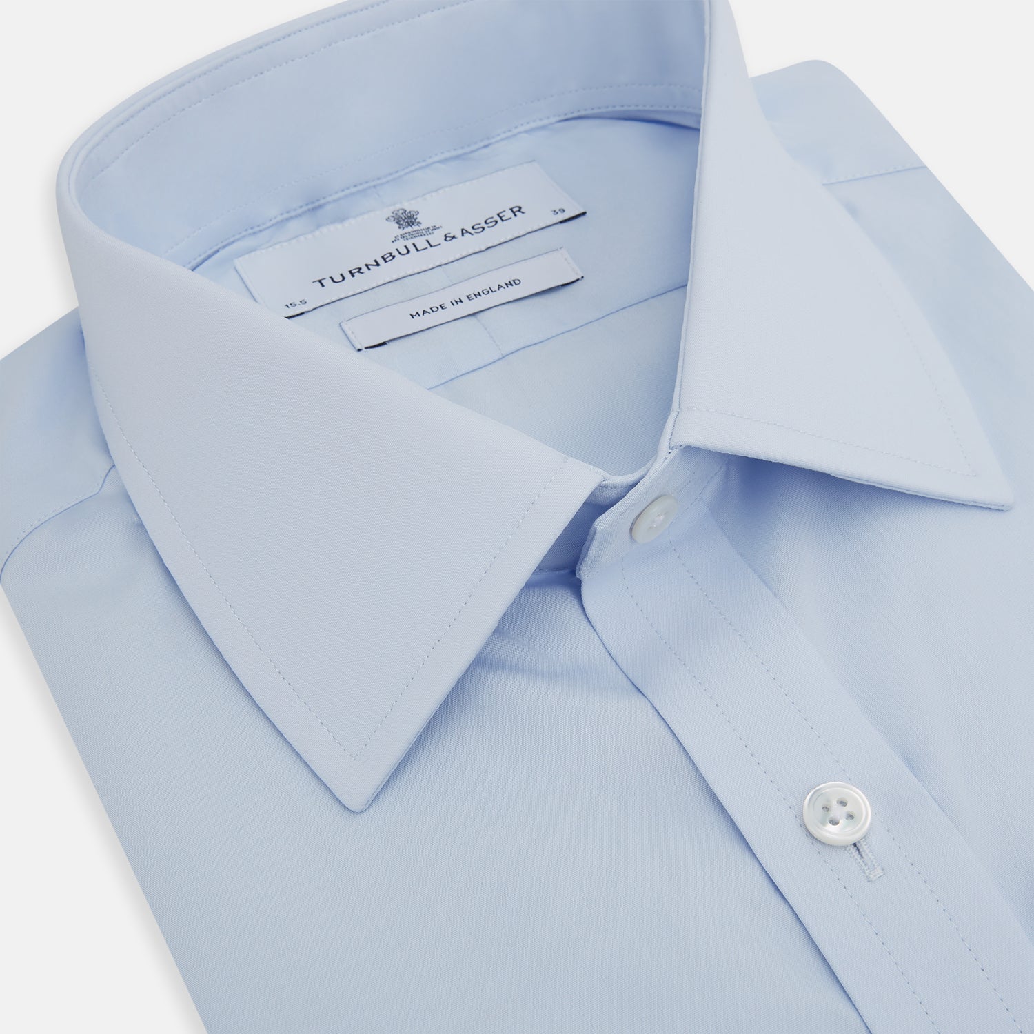View 2 of product The Turnbull & Asser Light Blue Mayfair Shirt features white buttons, a classic collar, and buttoned cuffs—styled flat on a white background, it’s ideal for minimalist outfits or pairing with bold ties.