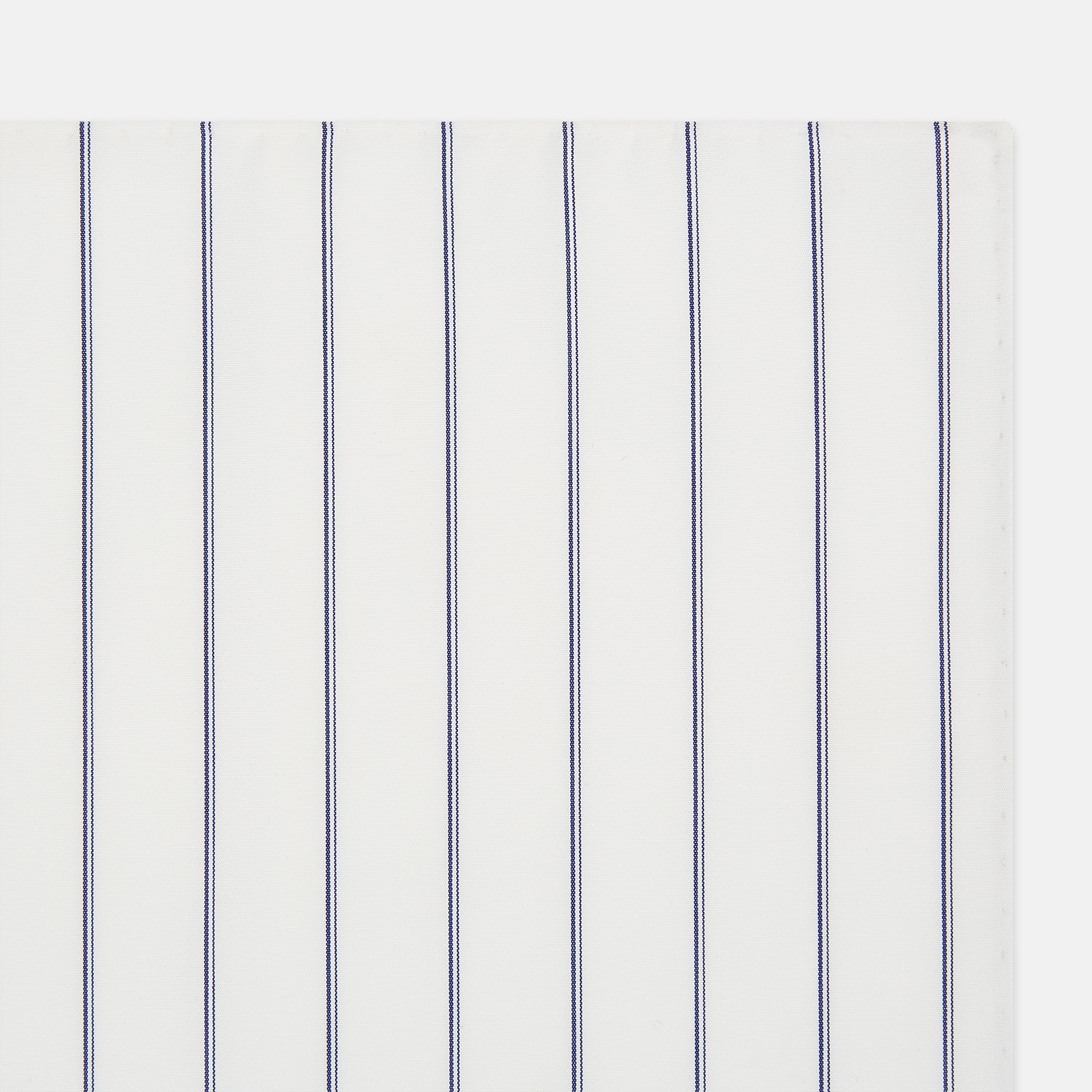 View 2 of product The Dark Navy Double-Pinstripe Hand-Rolled Handkerchief by Turnbull & Asser features white fabric with evenly spaced thin dark navy stripes and refined hand-rolled edges.