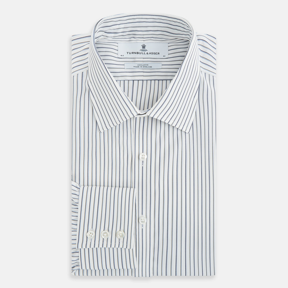 The Turnbull & Asser Brown and Blue Shadow Stripe Mayfair Shirt, featuring long sleeves, a pointed collar, and buttoned cuffs, is crafted from Italian fabric with vertical stripes and shown laid flat on a white background.