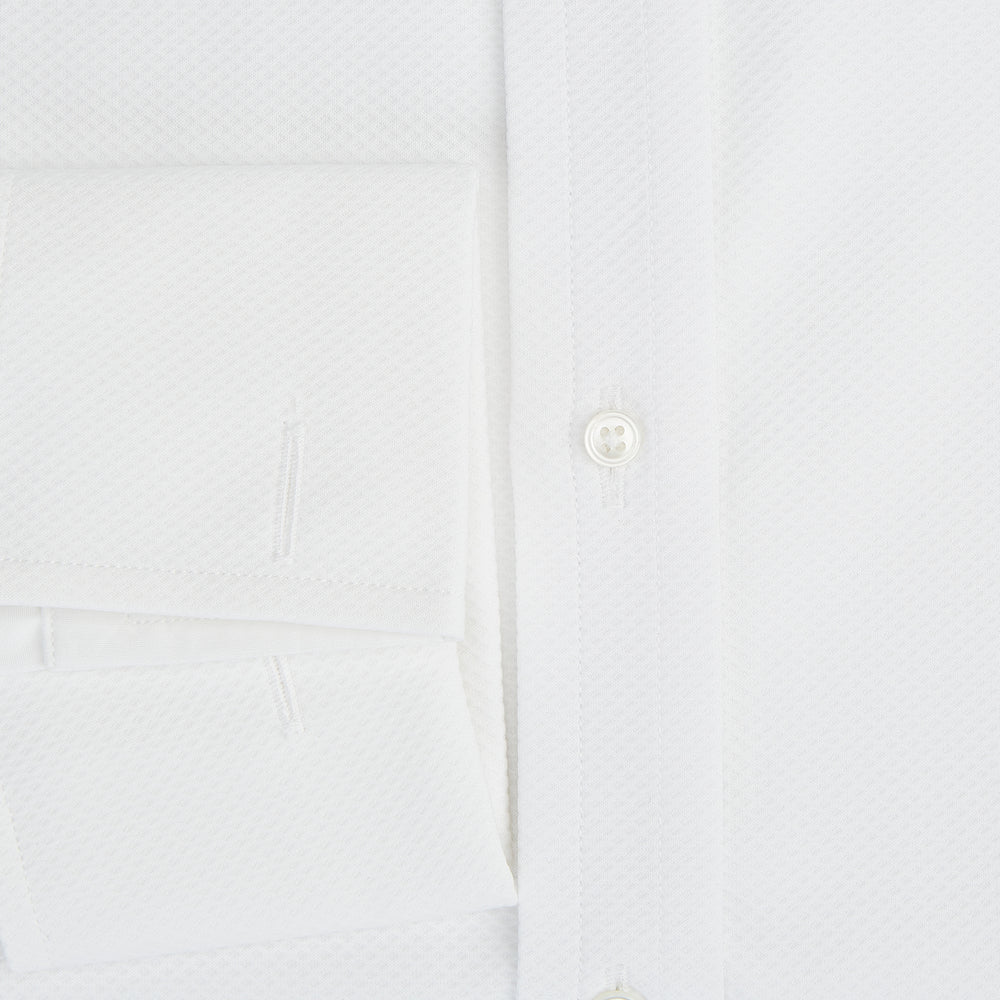 The Turnbull & Asser Tailored Fit White Marcella Front Shirt features a Kent Collar and double cuffs, shown laid flat on a white background. Perfect as a black tie shirt for formal events.