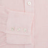 View 4 of product The Turnbull & Asser Pink Linen Shirt features a T&A collar, 3-button cuffs, and classic white buttons. This long-sleeved summer staple is shown on a plain white background.