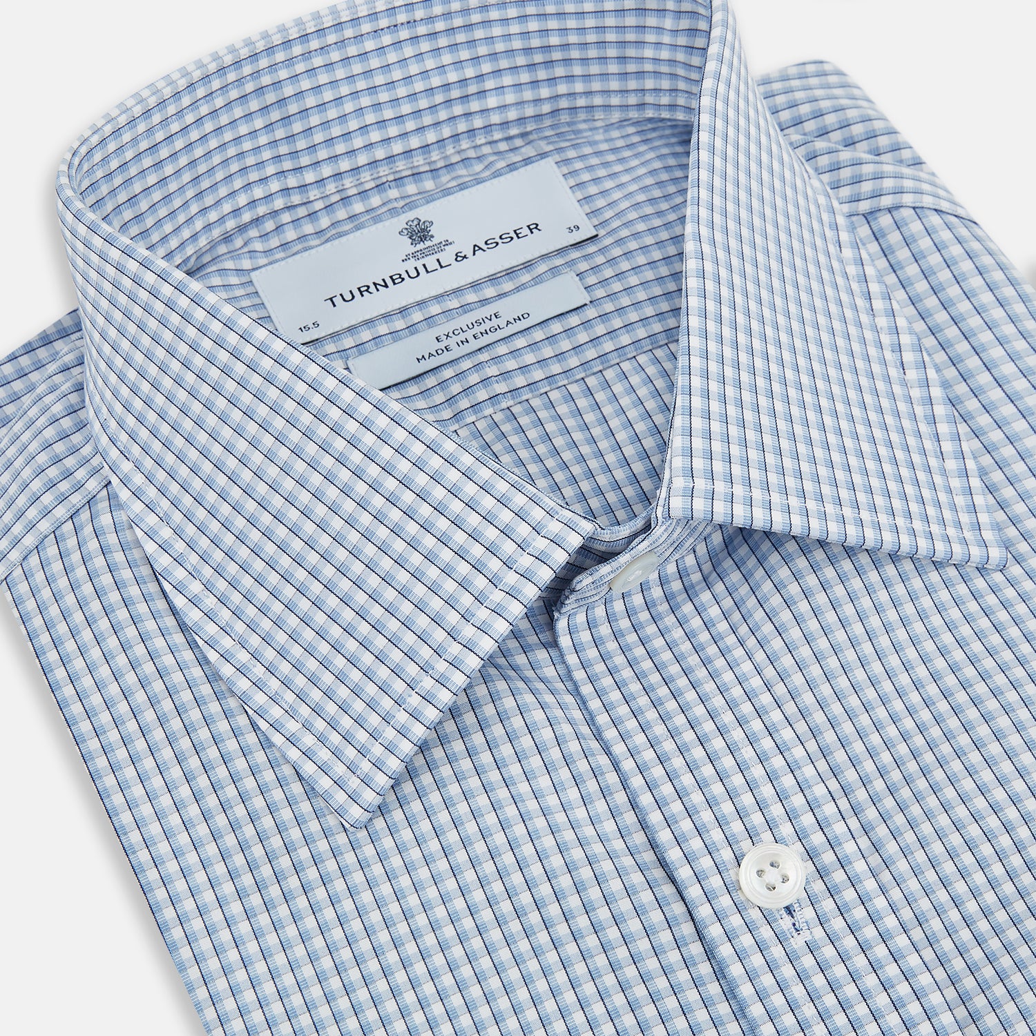 View 2 of product The Turnbull & Asser Blue Micro Shadow Check Mayfair Shirt features a long-sleeve, button-up design with a small blue and white check pattern, pointed T&A collar, and classic cuffs.