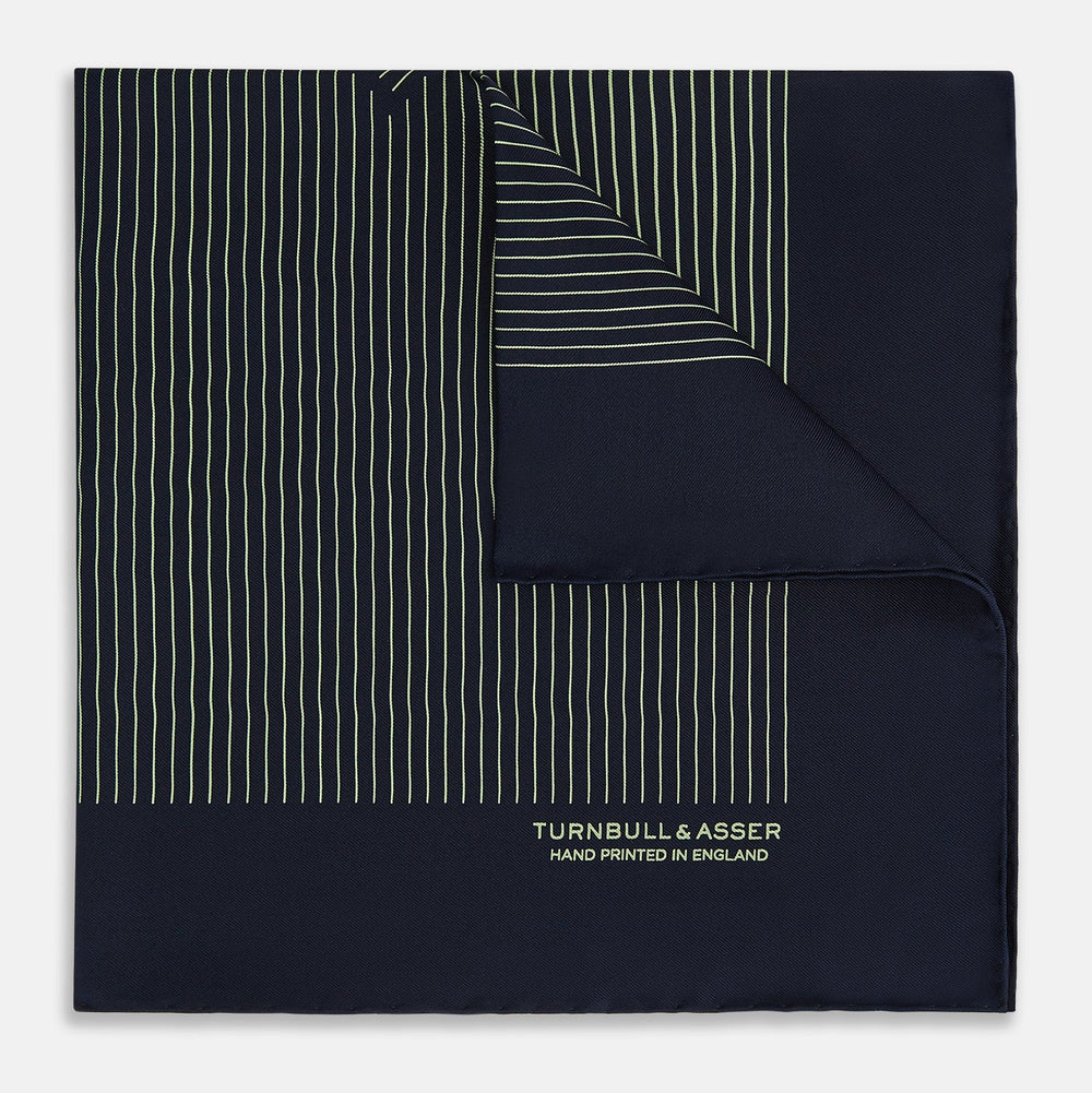 The Navy and Melon Green Stripe Silk Pocket Square by Turnbull & Asser features refined stripes, hand-printed branding in the corner, and is finished with elegant hand-rolled edges.