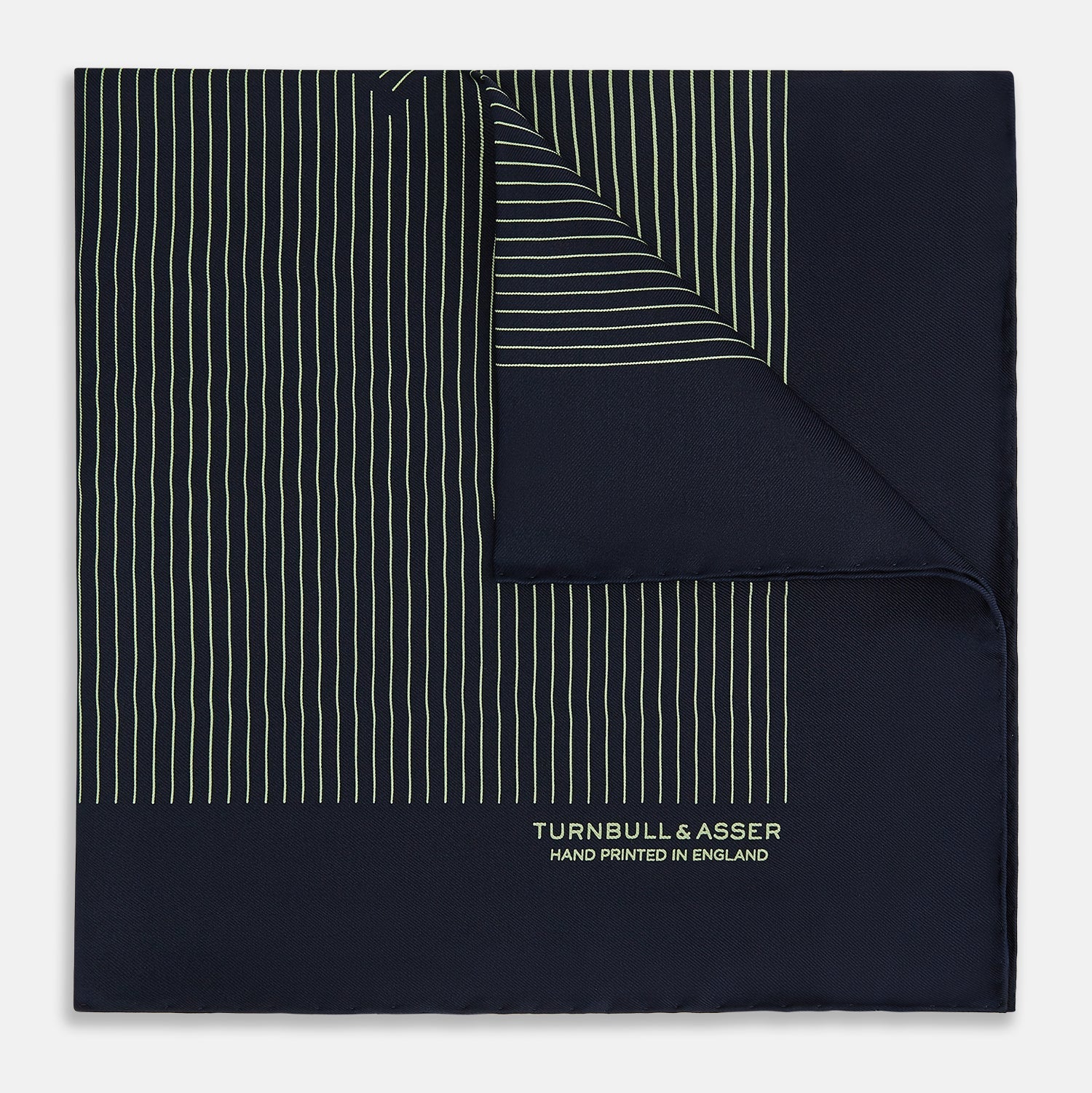 View 1 of product The Navy and Melon Green Stripe Silk Pocket Square by Turnbull & Asser features refined stripes, hand-printed branding in the corner, and is finished with elegant hand-rolled edges.