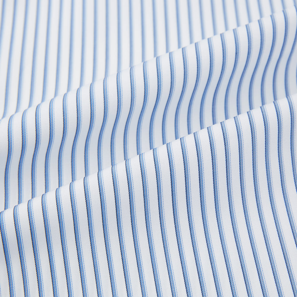 The Turnbull & Asser Blue Shadow Stripe Mayfair Shirt is a long-sleeve button-up with a T&A collar and thin blue vertical stripes on white, shown on a plain white background.