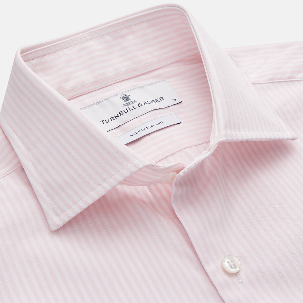 The Turnbull & Asser White and Pink Wide Stripe Belgravia Shirt features long sleeves, a classic collar, buttoned cuffs, and a wide stripe pattern—an elegant men's formal shirt from the Belgravia collection.