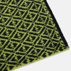 View 2 of product A Petrol Green and Chartreuse diamond-patterned cashmere knitted scarf by Turnbull & Asser—an essential accessory for adding striking geometric flair to any look.