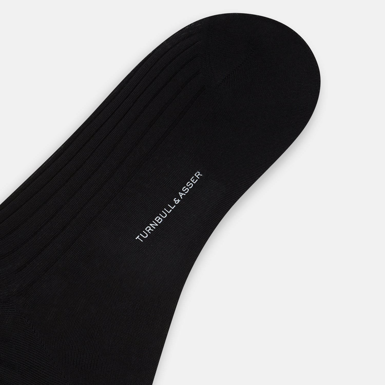 View 3 of product A single Black Cotton Mid-Length Sock by Turnbull & Asser, featuring a ribbed texture and crafted from premium Egyptian cotton, is displayed upright against a plain white background.