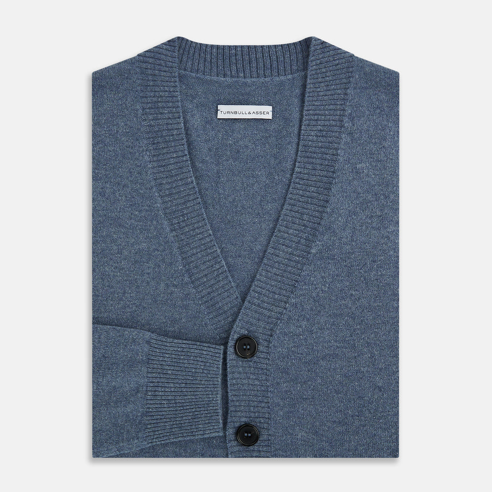 The Turnbull & Asser Blue Melange Cashmere Cardigan features a V-neck, black buttons, ribbed cuffs and hem, and two front pockets—ideal knitwear for versatile layering, shown here against a plain white background.