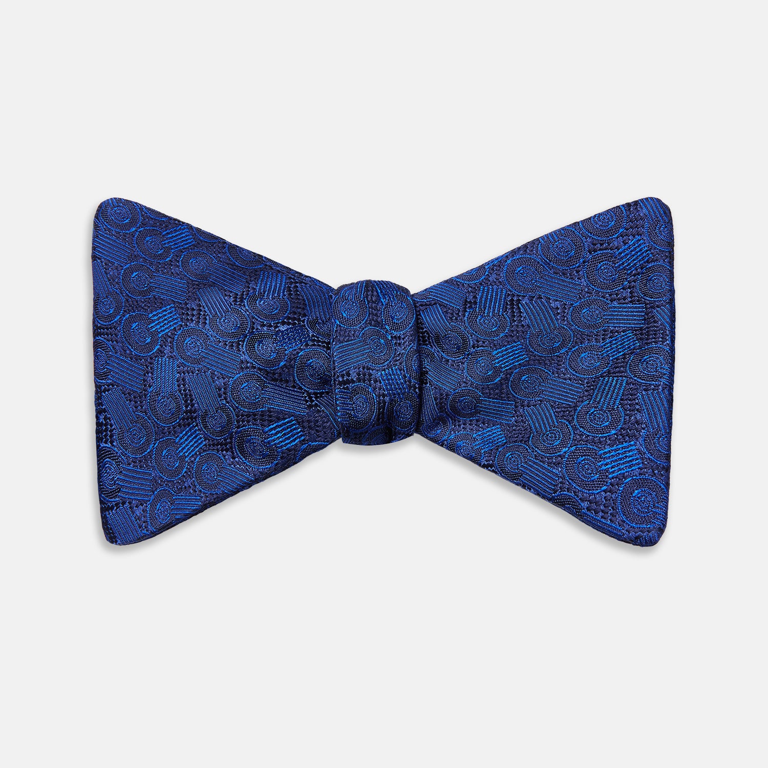 View 1 of product The Turnbull & Asser Electric Blue Motif Silk Bow Tie features subtle circular and swirl designs, shown on a plain white background—perfect for elevating formal attire.