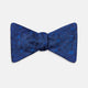 The Turnbull & Asser Electric Blue Motif Silk Bow Tie features subtle circular and swirl designs, shown on a plain white background—perfect for elevating formal attire.