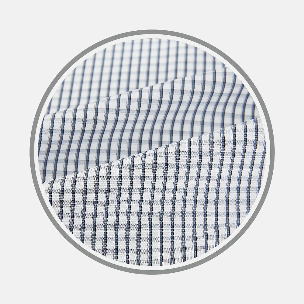 Close-up of Grey Double Graph Fabric by Turnbull & Asser, featuring a blue and gray plaid check pattern, shown within a circular frame on a light background.