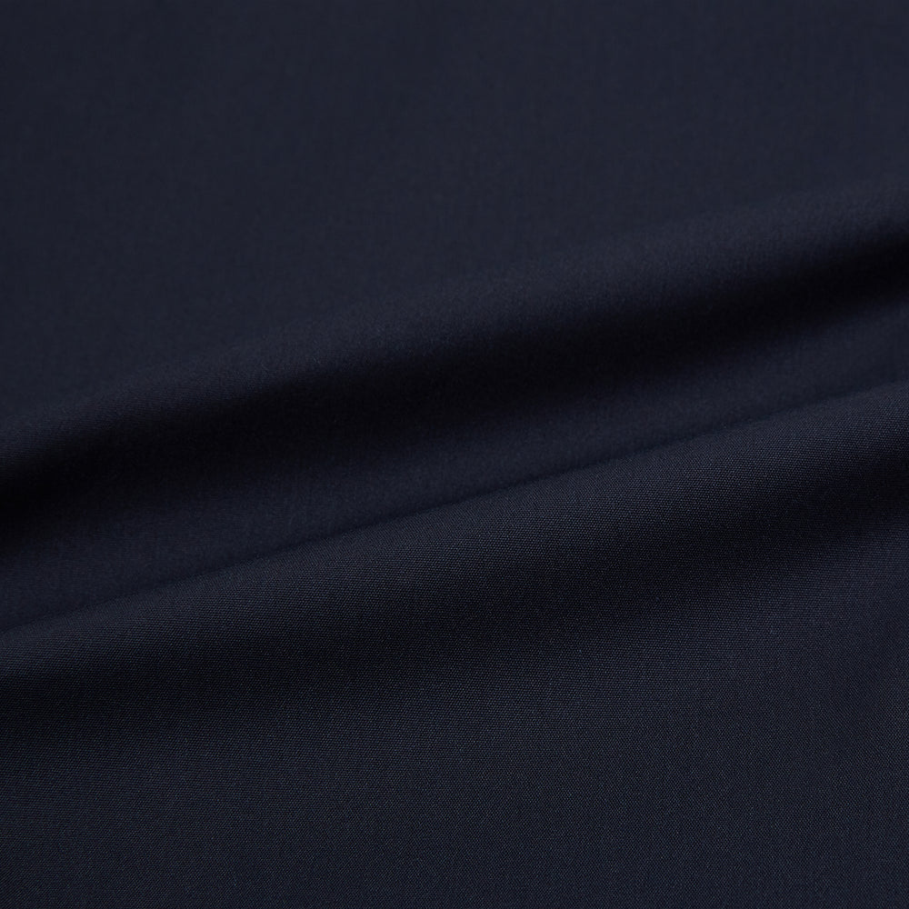 The Navy Westminster Shirt by Turnbull & Asser is a classic long-sleeve, button-up shirt with a pointed collar and buttoned cuffs, exemplifying British craftsmanship, shown against a plain white background.