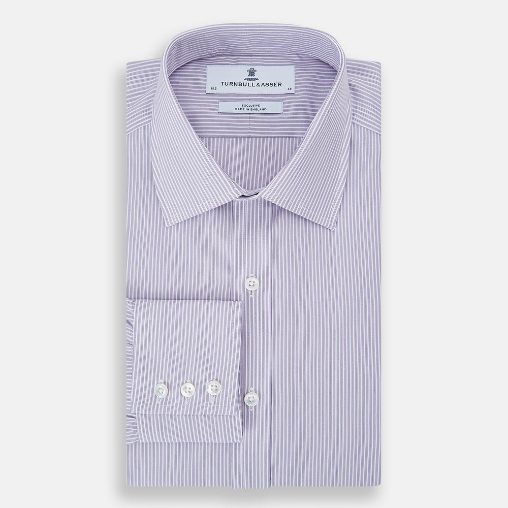 The Lilac Halo Stripe Mayfair Shirt by Turnbull & Asser features a relaxed Mayfair fit, white buttons, a pointed collar, and a subtle lilac stripe pattern for timeless sophistication.