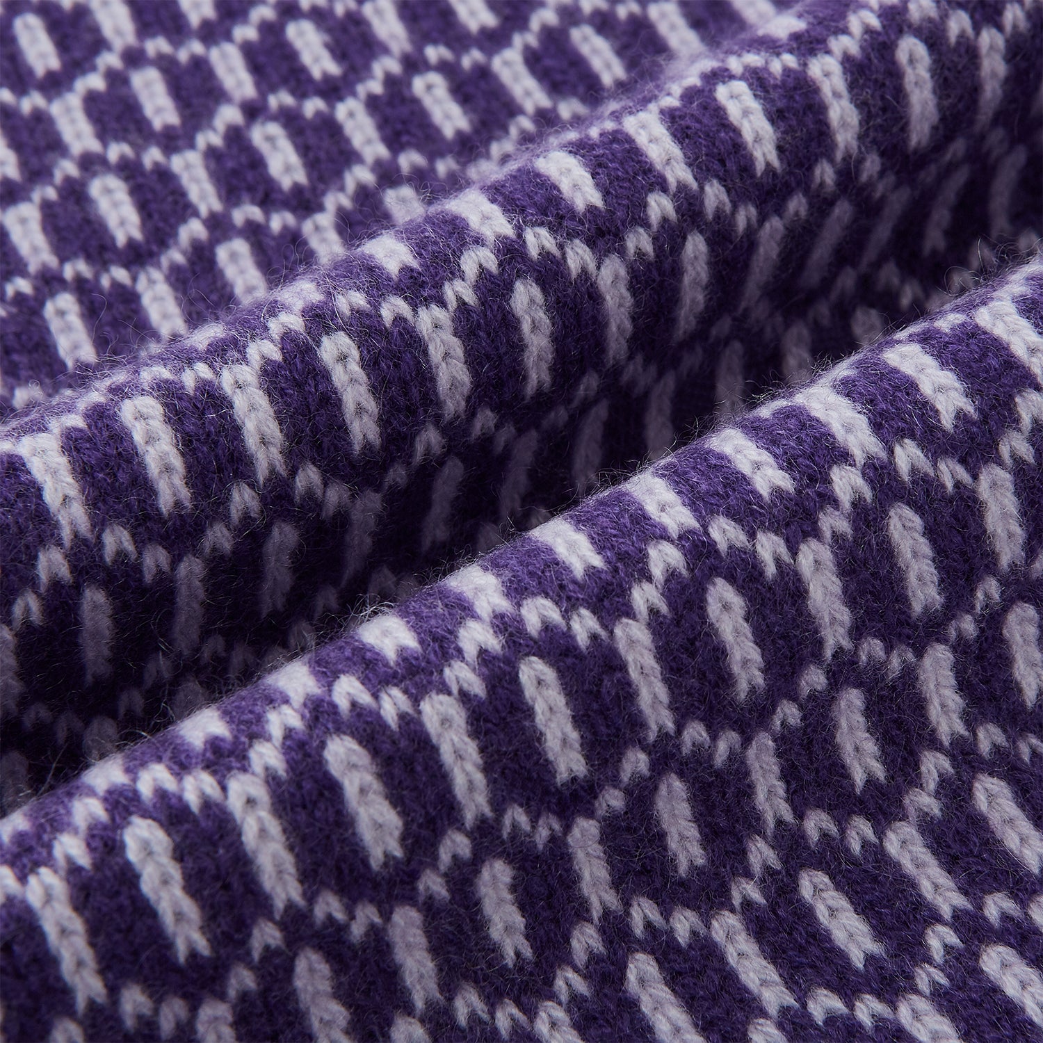 View 3 of product The Turnbull & Asser Purple and Lilac Hexagon Cashmere Knitted Scarf, featuring a white hexagon pattern, is neatly knotted and displayed on a plain background—a stylish accessory to elevate any outfit.
