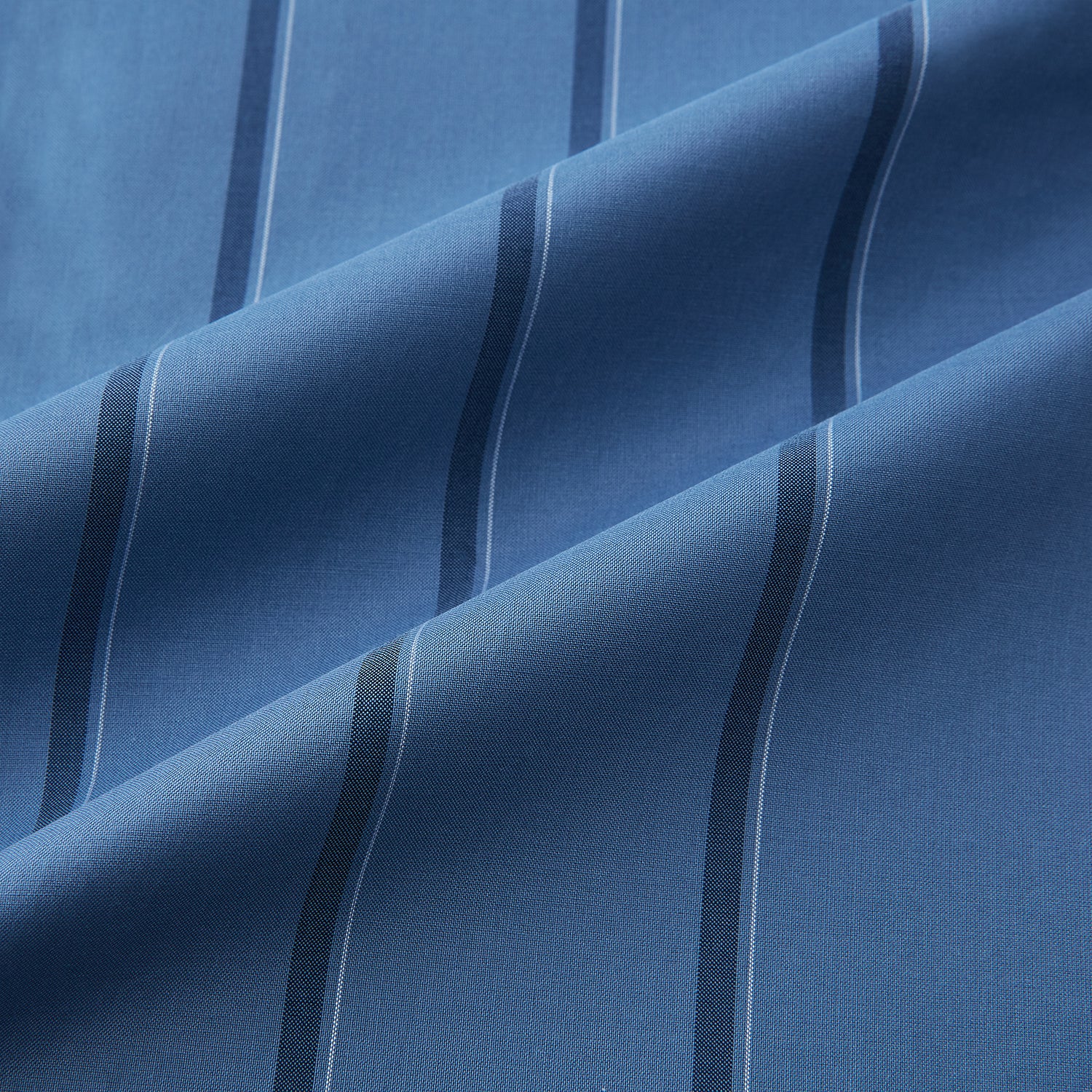 View 6 of product The Turnbull & Asser Steel Grey Track Stripe Shirt features vertical black stripes, a contrast white T&A collar, and white cuffs, shown against a plain light background.