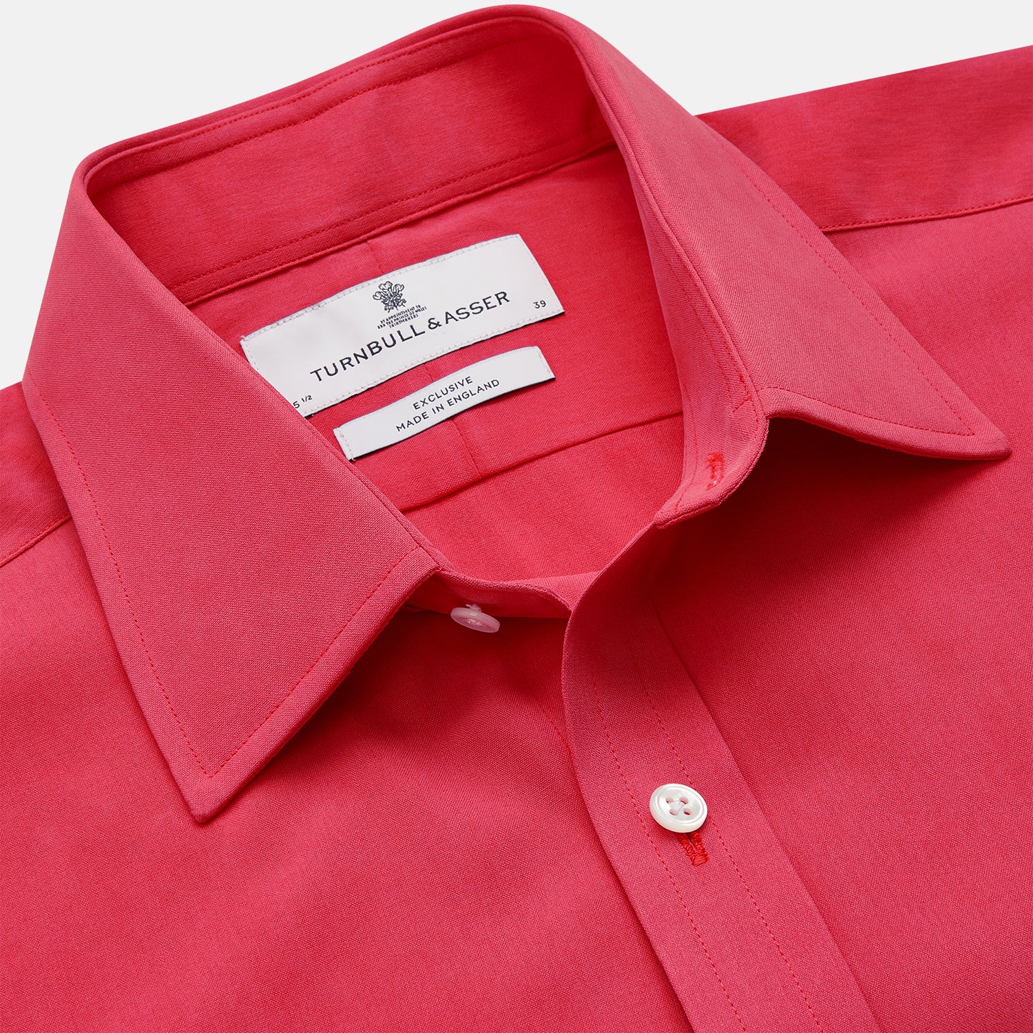 View 3 of product The Turnbull & Asser Coral Pink Silk Regular Fit Mayfair Shirt features long sleeves, a classic collar, and white buttons, displayed laid flat on a plain white background.