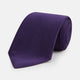 The HOUNDSTOOTH NAVY PLUM TIE by Turnbull & Asser, featuring a textured pattern, is showcased rolled up against a plain white background—an essential accessory.