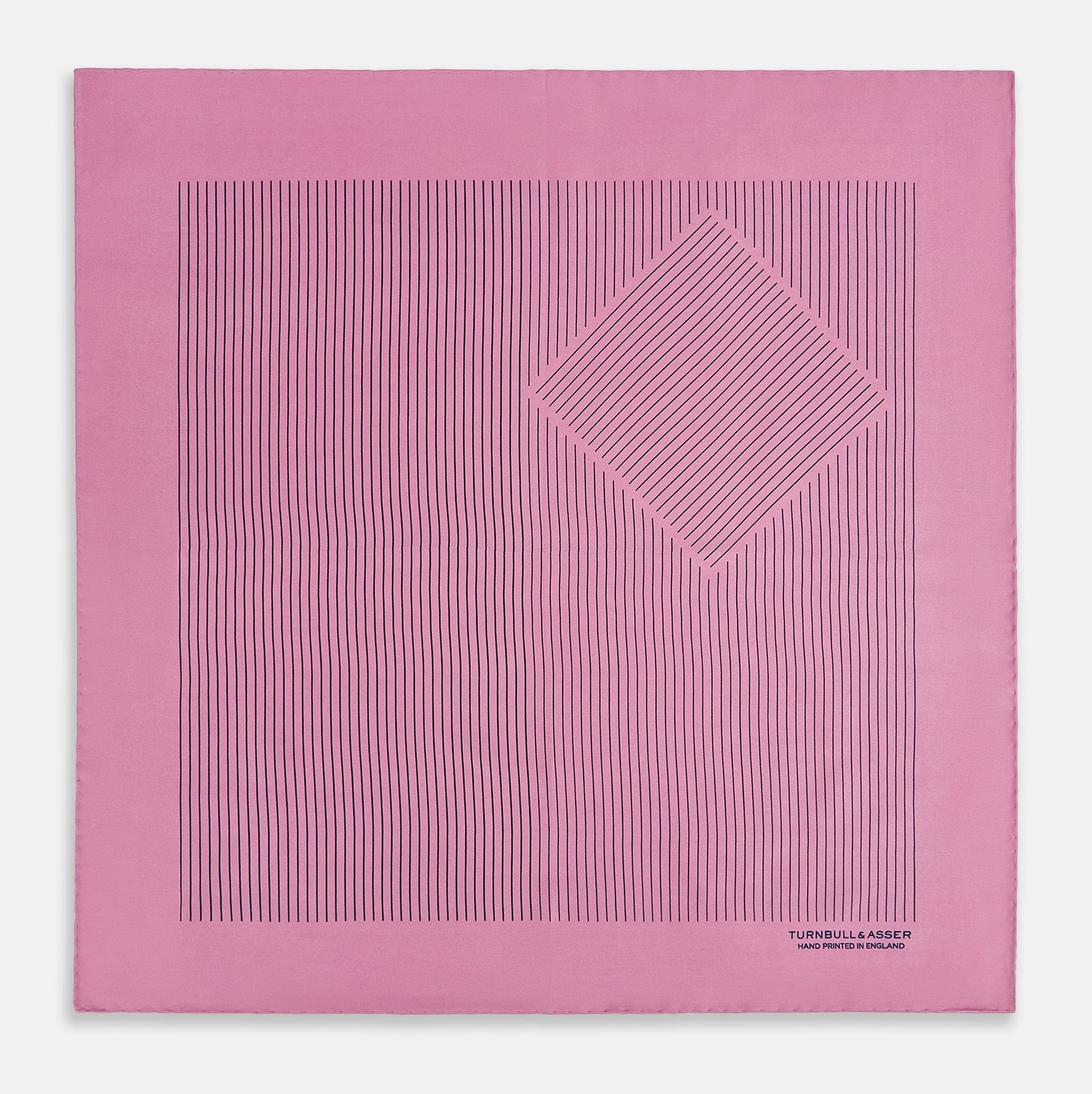 View 3 of product The Turnbull & Asser Pink Stripe Silk Pocket Square features thin vertical navy stripes and "TURNBULL & ASSER HAND PRINTED IN ENGLAND" in the bottom right corner, with one corner stylishly folded over.