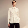 View 5 of product The Cream Silk Tailored Bianca Shirt by Turnbull & Asser features long sleeves, a pointed collar, and curved hem in soft-touch peace silk with a tailored fit. Shown laid flat on a white background.