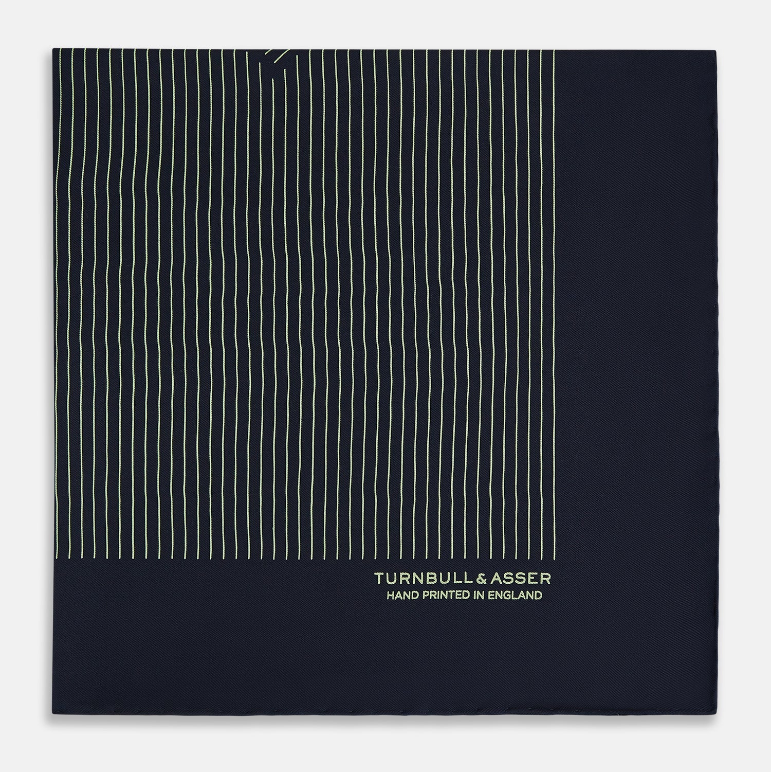 View 4 of product The Navy and Melon Green Stripe Silk Pocket Square by Turnbull & Asser features refined stripes, hand-printed branding in the corner, and is finished with elegant hand-rolled edges.