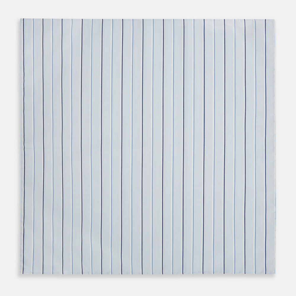 The Turnbull & Asser Navy and Blue Combination Stripe Hand-Rolled Handkerchief features a light blue base with evenly spaced dark blue pinstripes and refined hand-rolled edges, offering a classic, elegant look.
