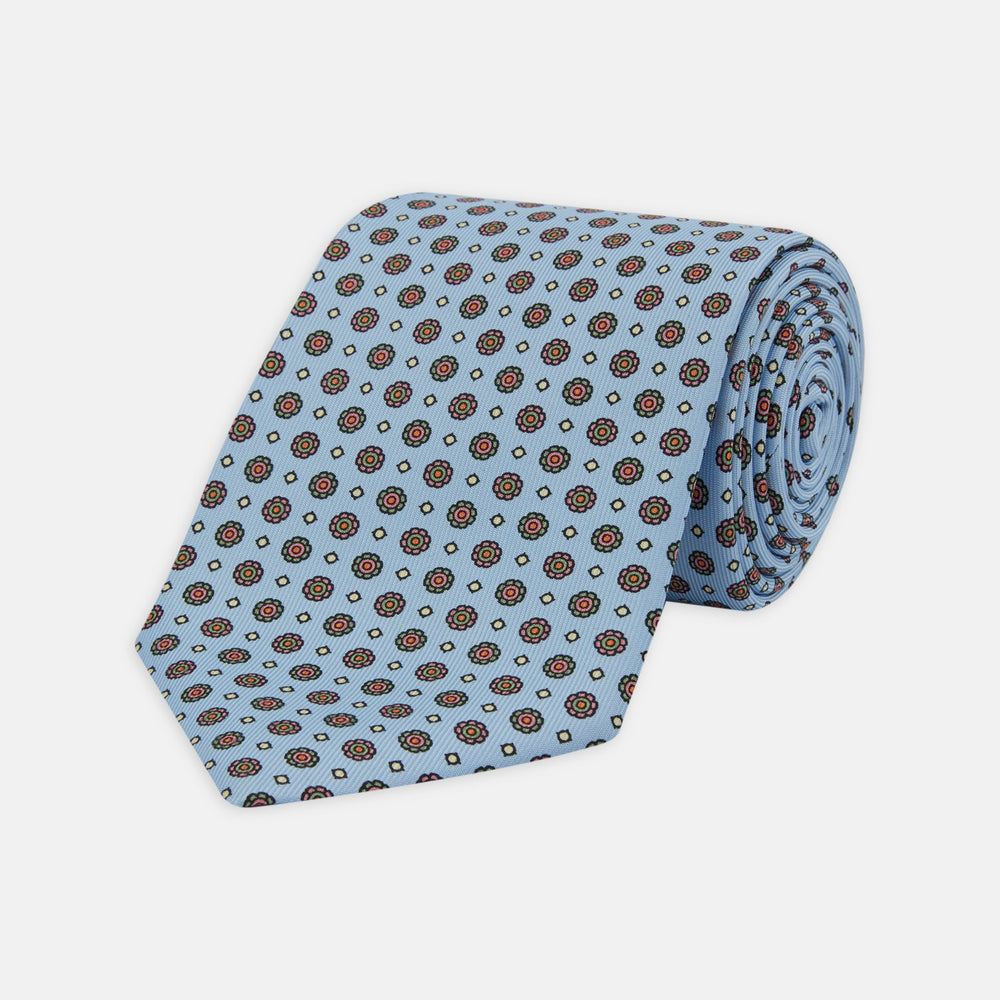 The Great Gatsby Silk Tie by Turnbull & Asser, as seen on Jay Gatsby—a light blue silk tie with red, yellow, and navy geometric floral motifs, ideal for classic 1920s-inspired shirts.