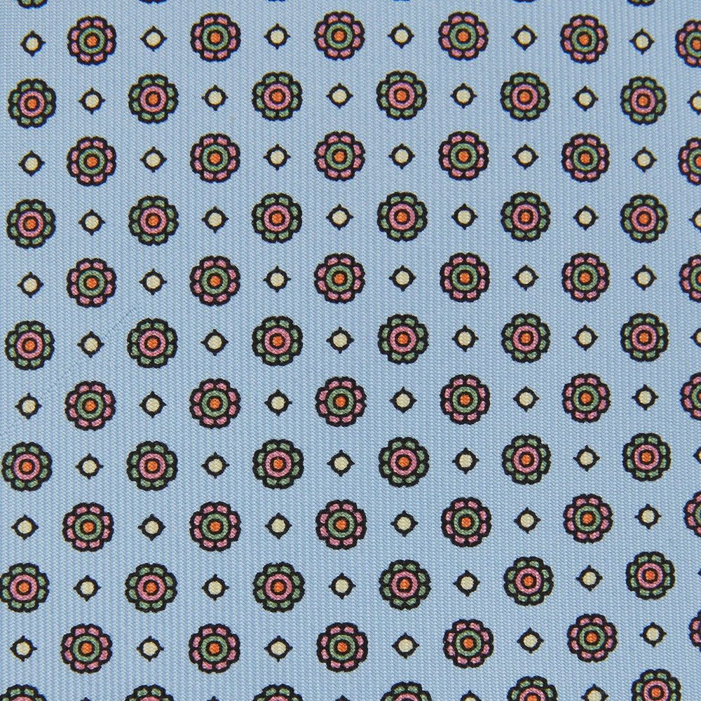 The Great Gatsby Silk Tie by Turnbull & Asser, as seen on Jay Gatsby—a light blue silk tie with red, yellow, and navy geometric floral motifs, ideal for classic 1920s-inspired shirts.