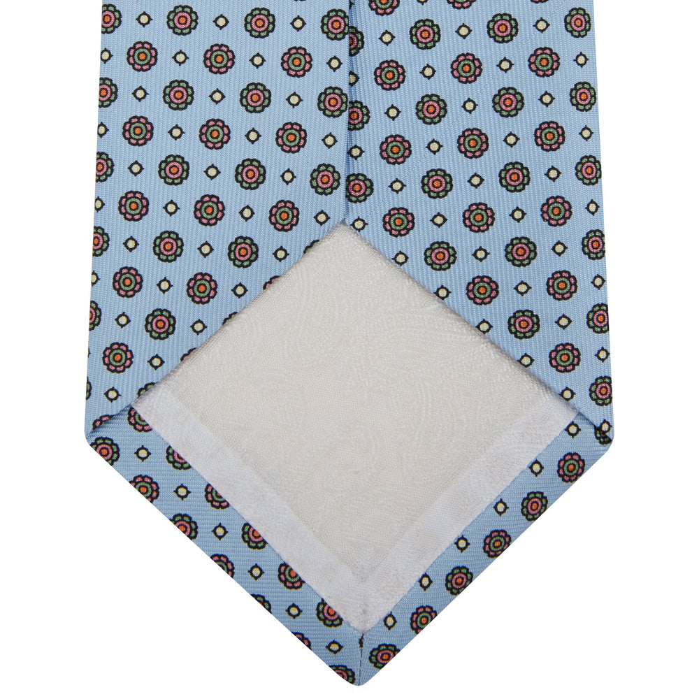 The Great Gatsby Silk Tie by Turnbull & Asser, as seen on Jay Gatsby—a light blue silk tie with red, yellow, and navy geometric floral motifs, ideal for classic 1920s-inspired shirts.