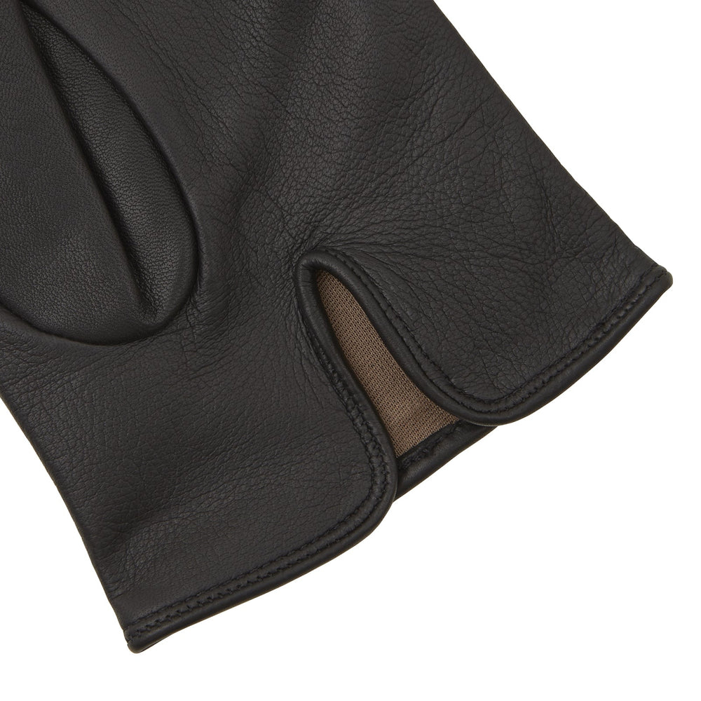 The Berkeley Black Leather Evening Gloves by Turnbull & Asser, one laid flat and the other resting partially on top, are displayed on a white background.