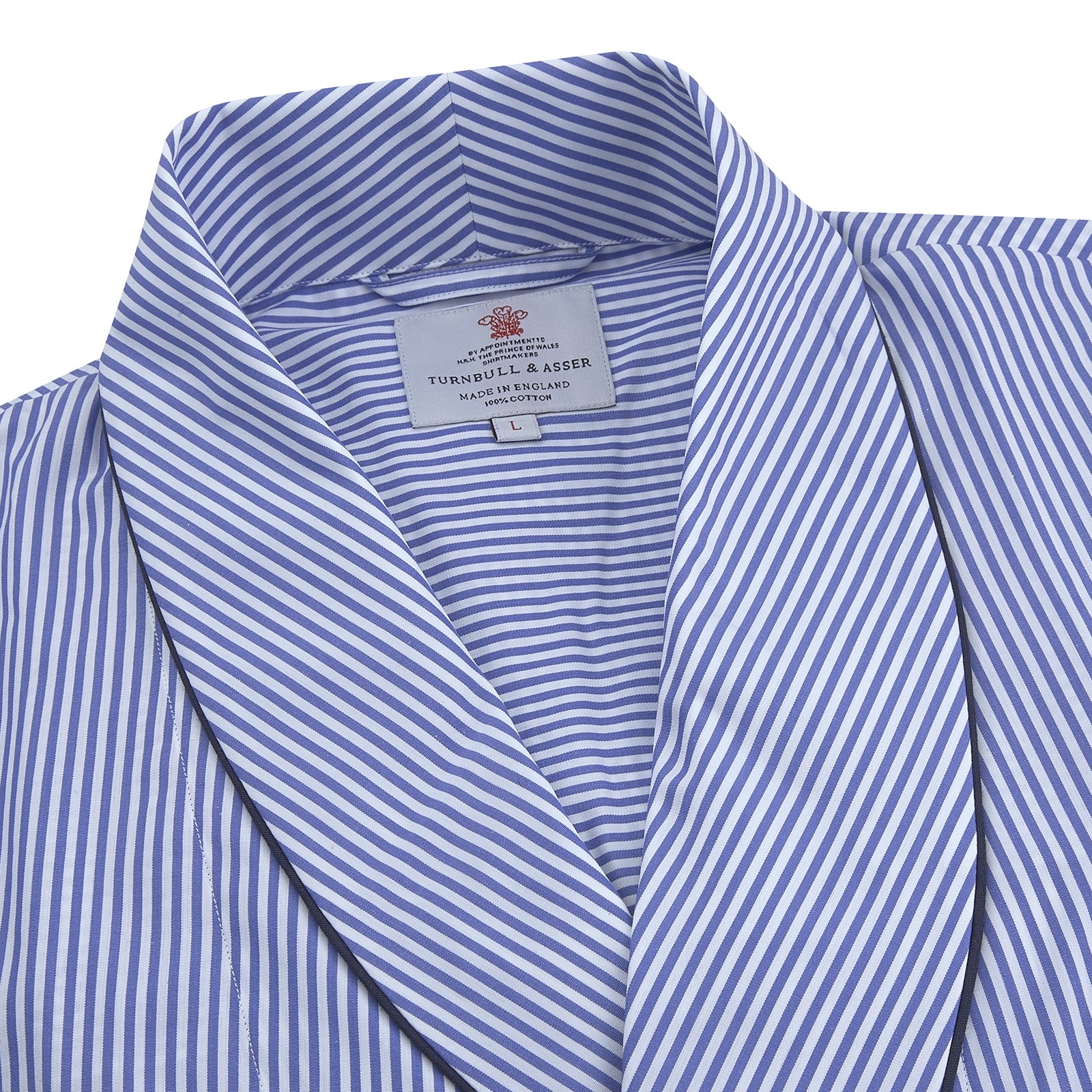 View 2 of product The Turnbull & Asser Blue Bengal Stripe Piped Cotton Gown, featuring a shawl collar and belt, is elegantly folded and displayed on a white background.
