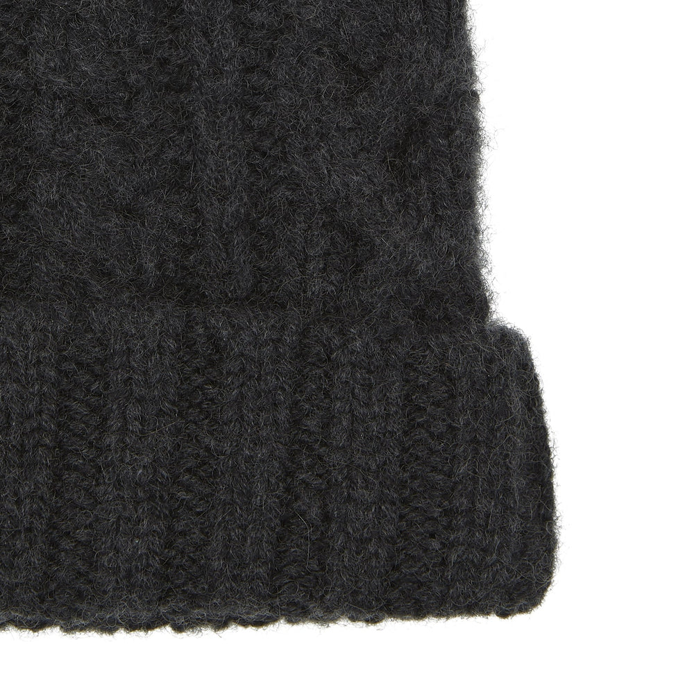 The Turnbull & Asser Charcoal Cable Knit Cashmere Hat features a ribbed fold-over cuff and textured pattern, ideal for winter, shown laid flat on a white background.