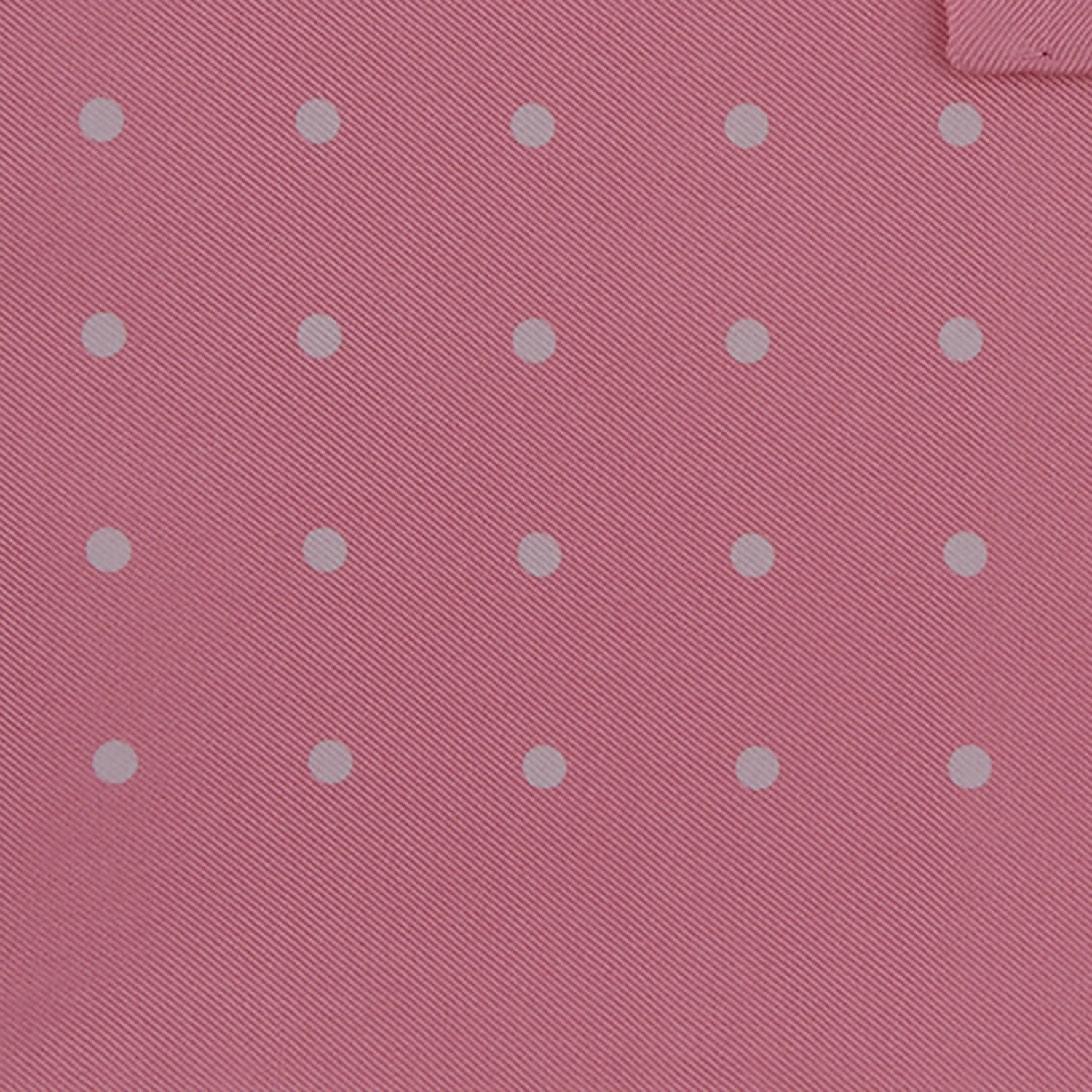 View 3 of product The Rose and White Spot Silk Pocket Square by Turnbull & Asser features rose pink silk with white polka dots and Turnbull & Asser branding in the corner—a refined accessory for any navy suit collection.