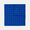 View 1 of product The Royal Blue Spot Silk Pocket Square by Turnbull & Asser features evenly spaced white polka dots and a branded corner, making it the perfect accessory to add flair to pinstripe suits.