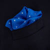 View 4 of product The Royal Blue Spot Silk Pocket Square by Turnbull & Asser features evenly spaced white polka dots and a branded corner, making it the perfect accessory to add flair to pinstripe suits.