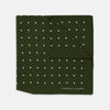 View 1 of product The Turnbull & Asser Olive Spot Silk Pocket Square features white polka dots, the brand’s logo in one corner, and a stylishly folded tip for a dapper finish.