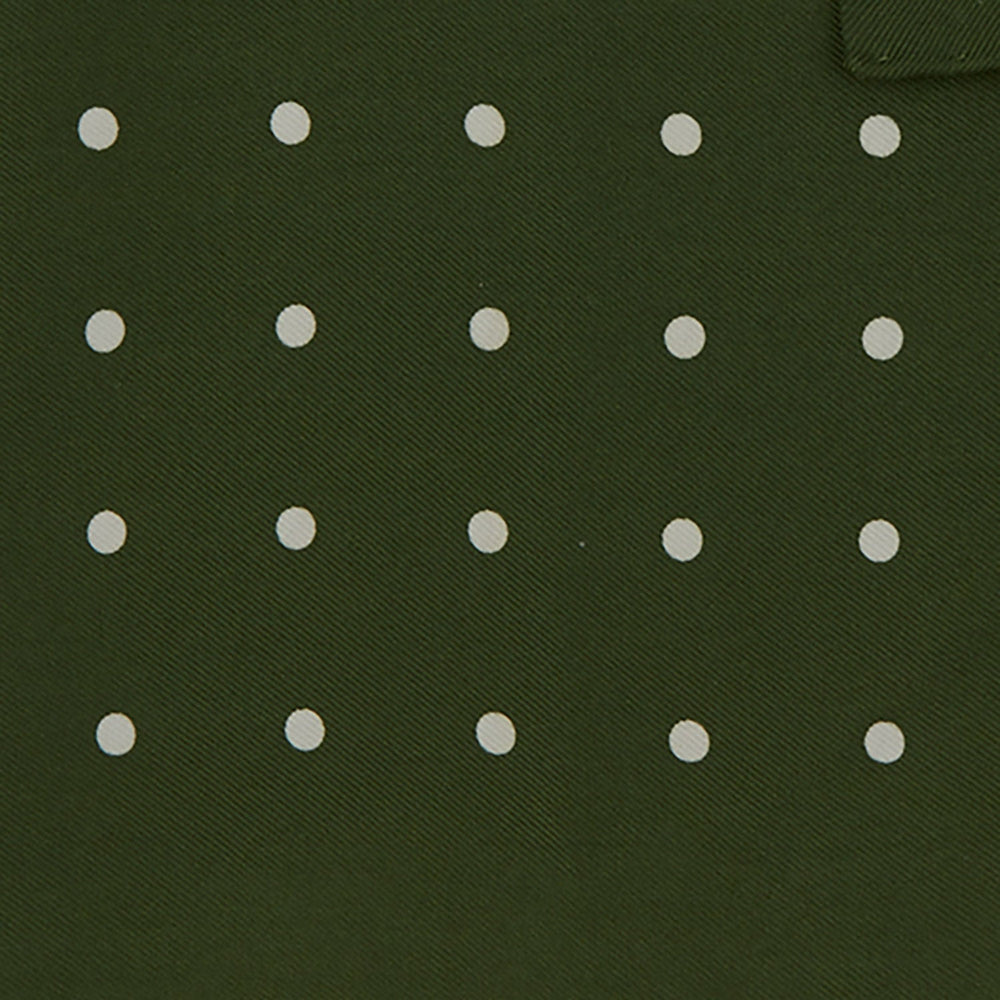 The Turnbull & Asser Olive Spot Silk Pocket Square features white polka dots, the brand’s logo in one corner, and a stylishly folded tip for a dapper finish.