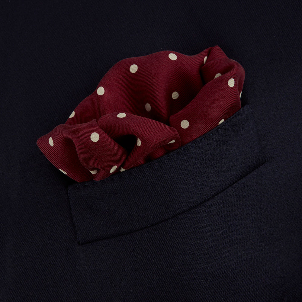 Add a touch of elegance with the Turnbull & Asser Burgundy Spot Silk Pocket Square, featuring white dots, a printed corner logo, and folded edging—a classic men’s accessory for any occasion.