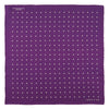 View 2 of product The Turnbull & Asser Purple Spot Silk Pocket Square features white polka dots and a small logo in the corner, with one corner folded over to showcase the underside.