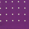 View 3 of product The Turnbull & Asser Purple Spot Silk Pocket Square features white polka dots and a small logo in the corner, with one corner folded over to showcase the underside.