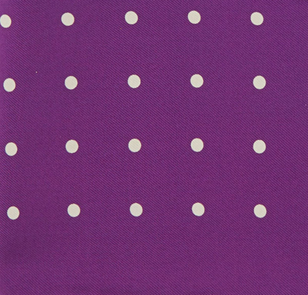 The Turnbull & Asser Purple Spot Silk Pocket Square features white polka dots and a small logo in the corner, with one corner folded over to showcase the underside.