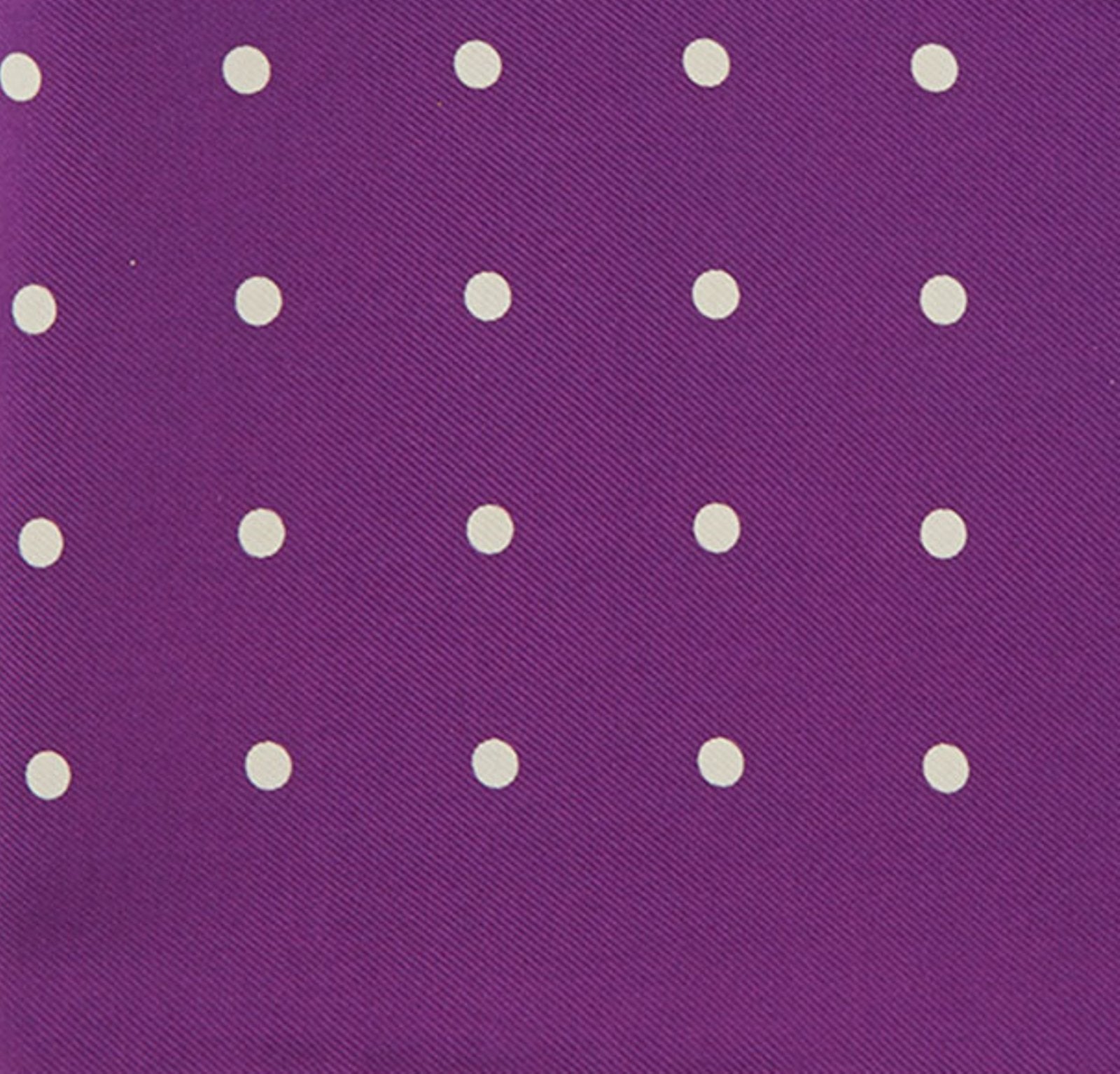 View 3 of product The Turnbull & Asser Purple Spot Silk Pocket Square features white polka dots and a small logo in the corner, with one corner folded over to showcase the underside.