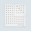 View 1 of product The Turnbull & Asser White and Black Spot Silk Pocket Square for men features evenly spaced black dots, a partial corner fold, and the brand name printed in black in the lower right corner.