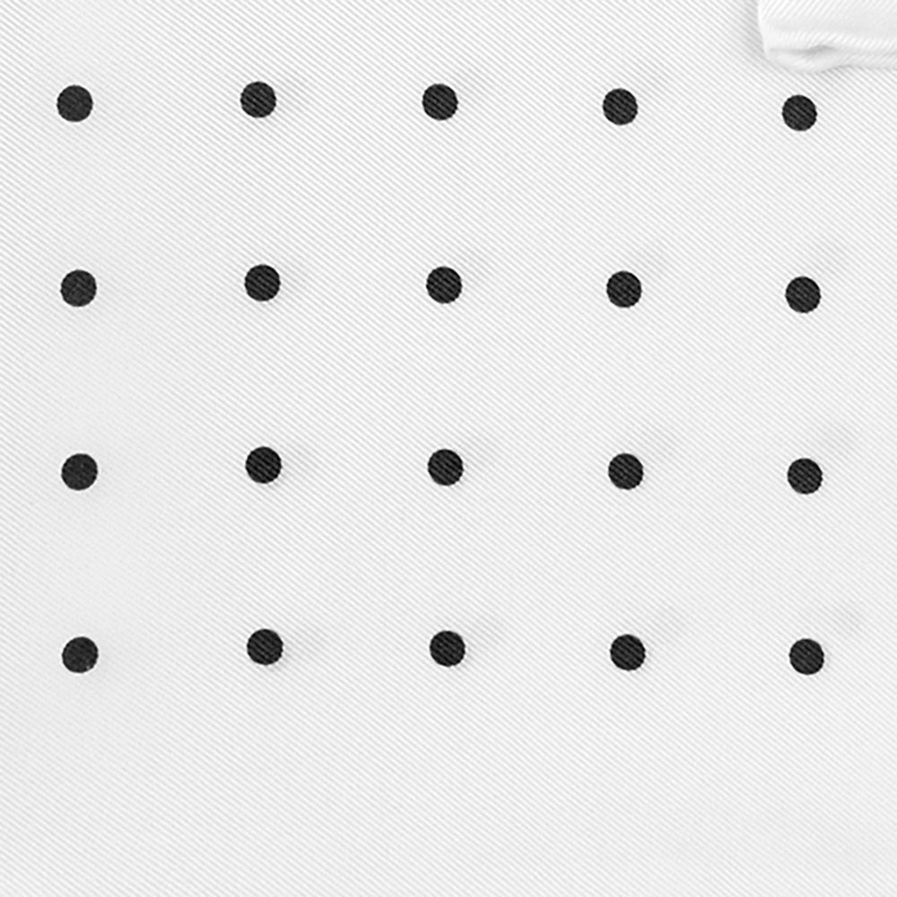 The Turnbull & Asser White and Black Spot Silk Pocket Square for men features evenly spaced black dots, a partial corner fold, and the brand name printed in black in the lower right corner.