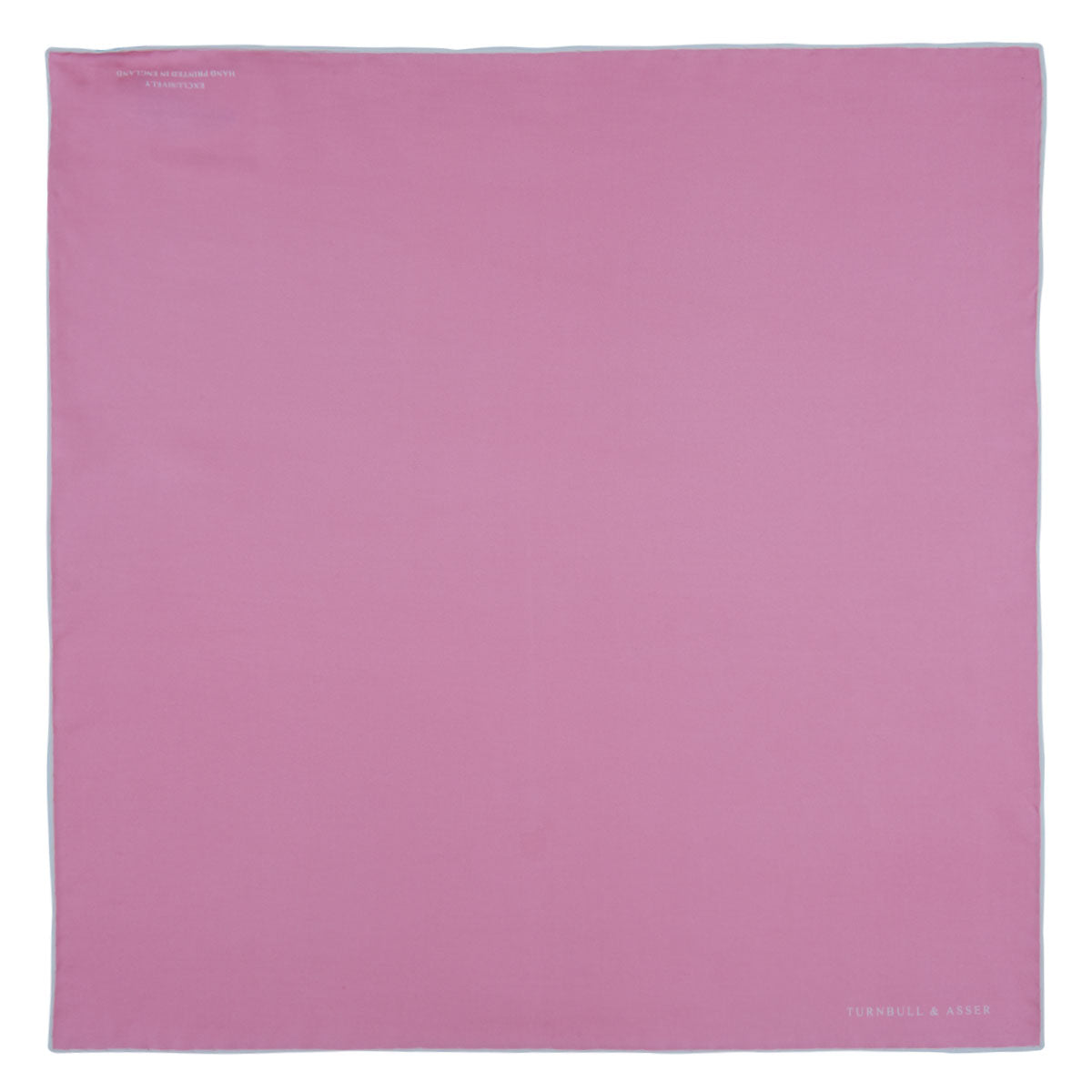 View 2 of product The Pink and White Piped Silk Pocket Square by Turnbull & Asser, featuring the brand’s name in white on one corner, is elegantly folded and set against a plain white background.