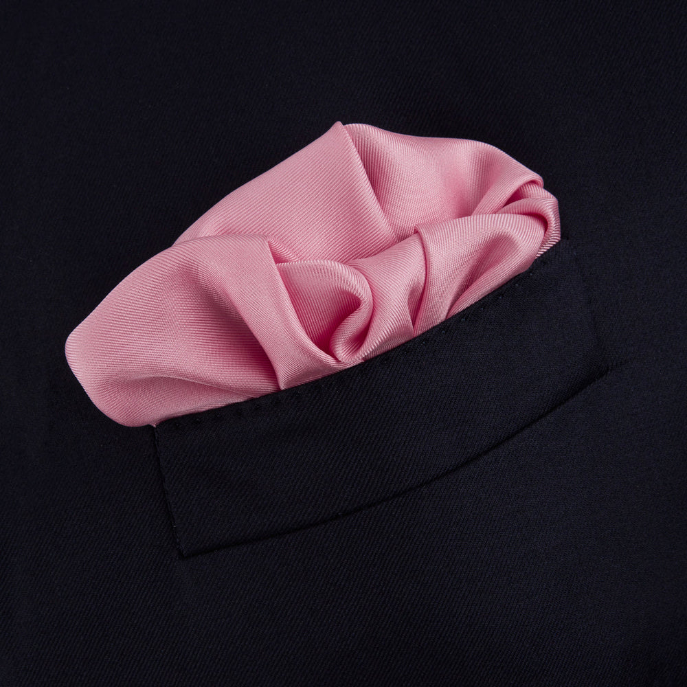 The Pink and White Piped Silk Pocket Square by Turnbull & Asser, featuring the brand’s name in white on one corner, is elegantly folded and set against a plain white background.