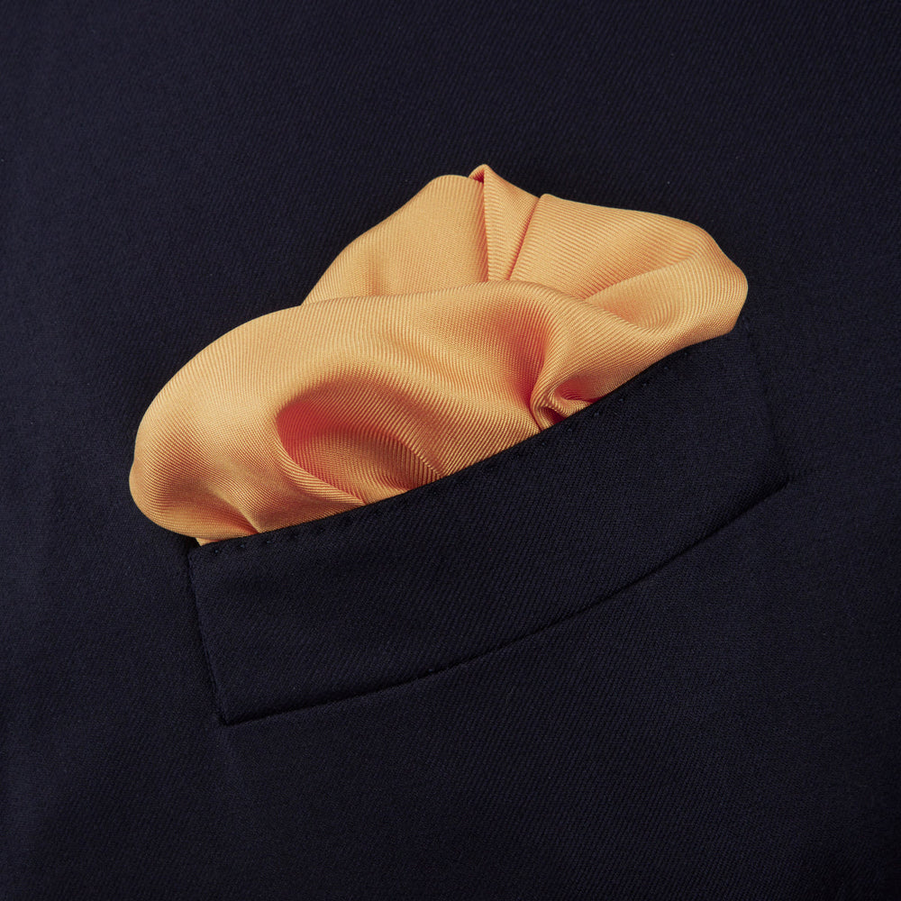 The Gold and White Piped Silk Pocket Square by Turnbull & Asser features neat white edging and TURNBULL & ASSER printed in one corner—a timeless silk accessory for any wardrobe.