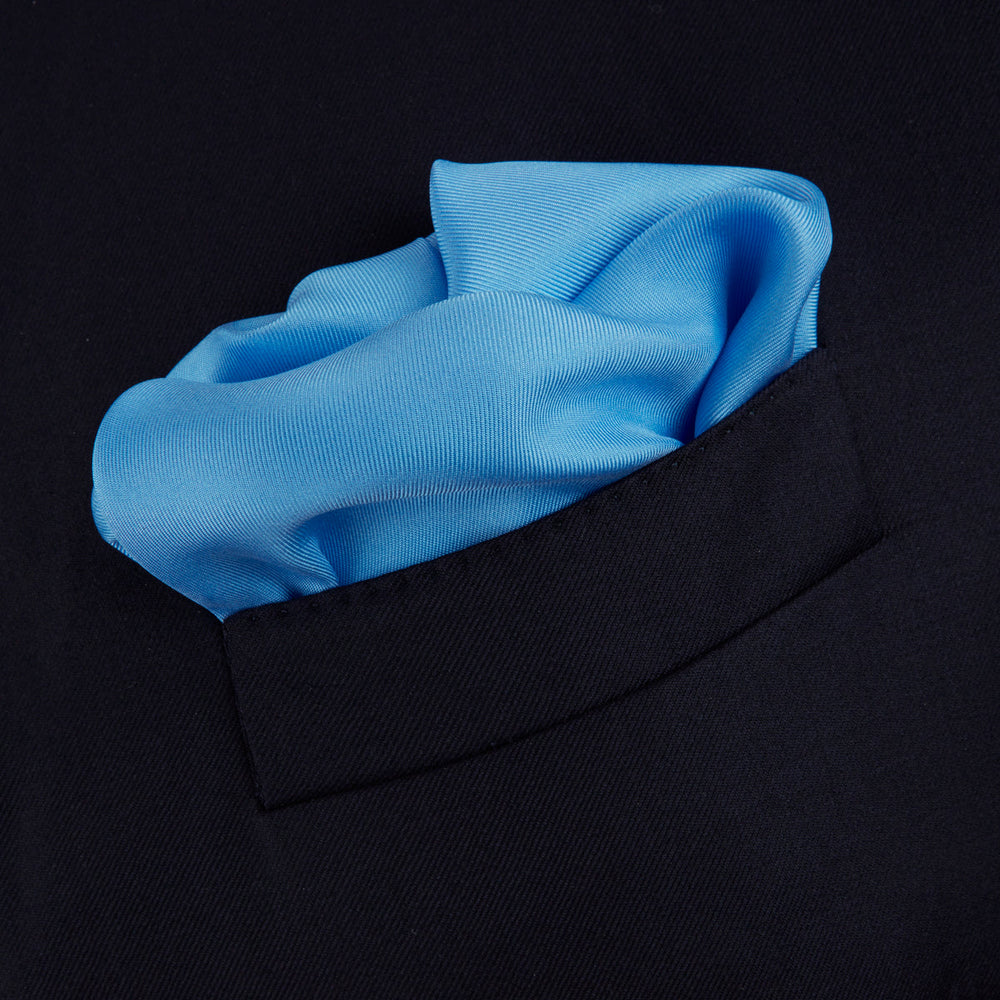 A Blue and White Piped Silk Pocket Square by Turnbull & Asser, neatly folded with the brand name in white on the lower right corner, displayed against a plain white background.