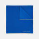 The Royal Blue Piped Silk Pocket Square by Turnbull & Asser features a vibrant blue hue, subtle stitched border, and the brand name printed in white in the lower right corner.