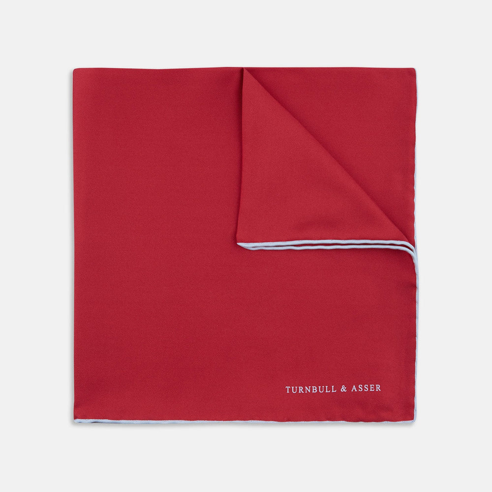 A classic accessory, the Turnbull & Asser Red and White Piped Silk Pocket Square is neatly folded to showcase both colors, with the brand’s logo in white on the corner.